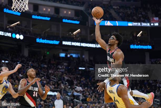 Scoot Henderson of the Portland Trail Blazers gets called for an offensive foul on Moses Moody of the Golden State Warriors during the second quarter...