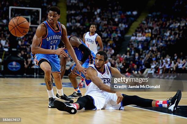 Darius Morris of the Philadelphia 76ers tussles with Jeremy Lamb of the Oklahoma City Thunder during the NBA pre season match between Oklahoma City...