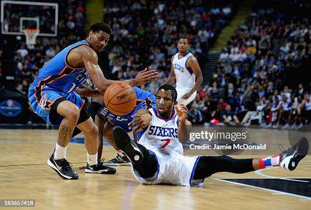 Darius Morris of the Philadelphia 76ers tussles with Jeremy Lamb of the Oklahoma City Thunder during the NBA pre season match between Oklahoma City...