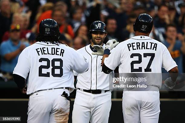 Jhonny Peralta of the Detroit Tigers celebrates his three run home run in the fifth inning with Prince Fielder and Alex Avila during Game Four of the...