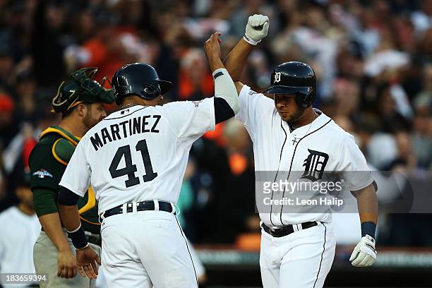 Jhonny Peralta of the Detroit Tigers celebrates his three run home run in the fifth inning with Victor Martinez during Game Four of the American...