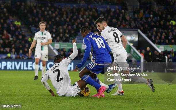 Leicester City's Abdul Fatawu battles with Plymouth Argyle's Bali Mumba and Joe Edwards during the Sky Bet Championship match between Leicester City...