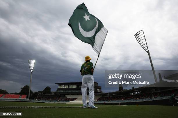 The Pakistan flag bearer is seen during day two of the Tour Match between PMs XI and Pakistan at Manuka Oval on December 07, 2023 in Canberra,...