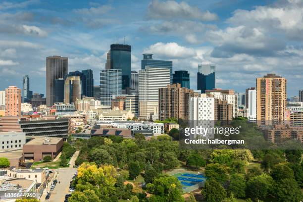 drone shot looking over loring park towards downtown skyscrapers - minneapolis aerial stock pictures, royalty-free photos & images
