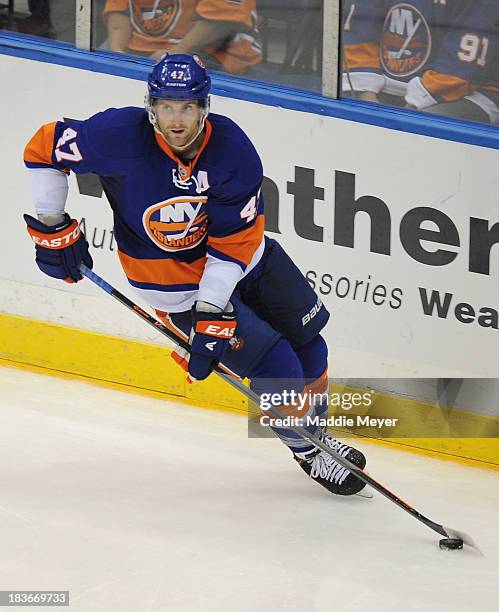 Andrew MacDonald of the New York Islanders carries the puck against the Phoenix Coyotes at Nassau Veterans Memorial Coliseum on October 8, 2013 in...