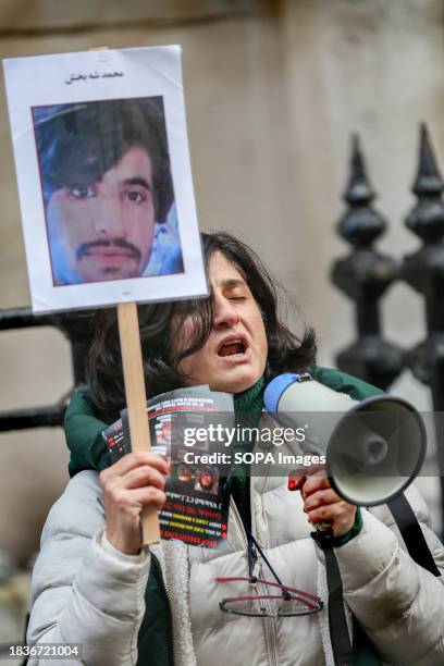 Protester closes her eyes and chants through a megaphone for an end to the executions in Iran. Protesters call on the United Nations to uphold the...