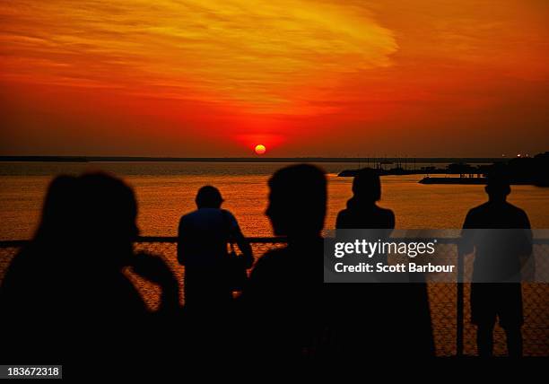 People watch the sunset over Port Darwin from Bicentennial Park on October 6, 2013 in Darwin, Australia. Darwin is the capital of the Northern...