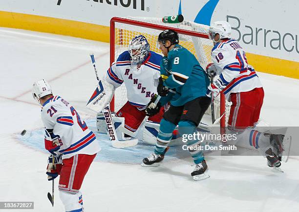 Joe Pavelski of the San Jose Sharks watches as Marc-Edouard Vlasic's shot goes in the net against Henrik Lundqvist, Marc Staal and Derek Stepan of...
