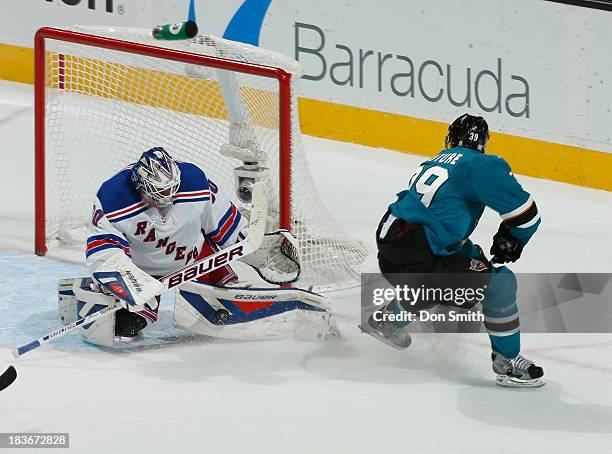 Logan Couture of the San Jose Sharks gets blocked on a break away by Henrik Lundqvist of the New York Rangers during an NHL game on October 8, 2013...