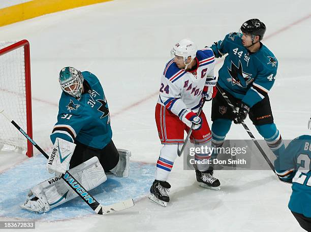 Antti Niemi and Marc-Edouard Vlasic of the San Jose Sharks protect the net against Ryan Callahan of the New York Rangers during an NHL game on...