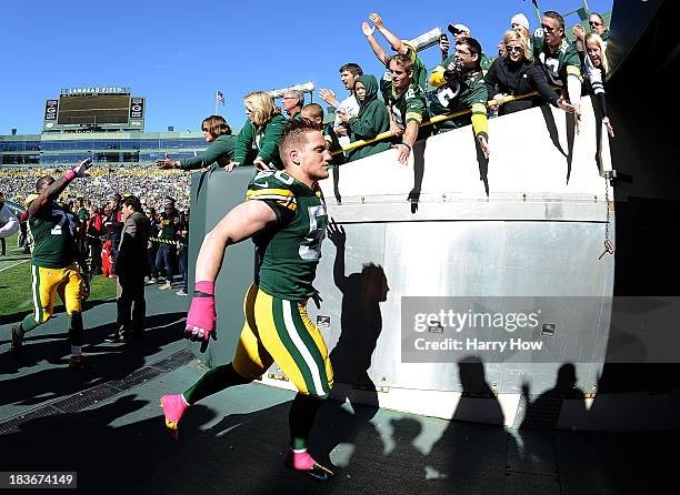 Hawk of the Green Bay Packers celebrates a 22-9 win over the Detroit Lions with fans as he leaves the field at Lambeau Field on October 6, 2013 in...