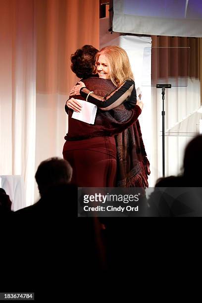Gloria Steinem and Women's Media Center Visionary Role Model and Corporate Leader Award winner, Sheila C. Johnson embrace onstage at the 2013 Women's...