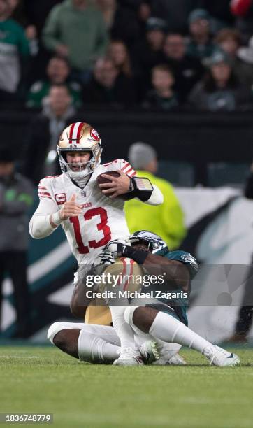 Fletcher Cox of the Philadelphia Eagles sacks Brock Purdy of the San Francisco 49ers during the game at Lincoln Financial Field on December 3, 2023...