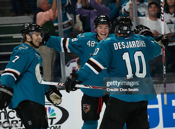 Tomas Hertl, Andrew Desjardins and Brad Stuart of the San Jose Sharks celebrate Hertl's goal against the New York Rangers during an NHL game on...