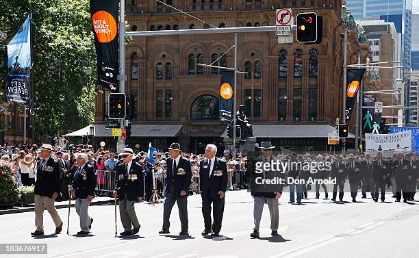 Retired Navy personnel are cheered on by the crowd as they march down George Street on October 9, 2013 in Sydney, Australia. Over 4,000 personnel...