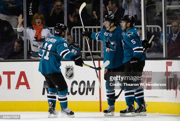 Tomas Hertl of the San Jose Sharks is congratulated by Tyler Kennedy and Jason Demers after he scored his fourth goal of the game against the New...