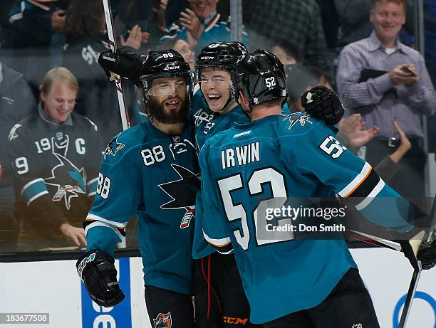 Tomas Hertl, Brent Burns and Matt Irwin of the San Jose Sharks celebrate Hertl's goal against the New York Rangers during an NHL game on October 8,...