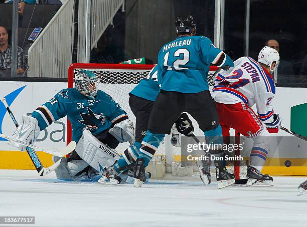 Antti Niemi and Patrick Marleau of the San Jose Sharks protect the net against Derek Stepan of the New York Rangers during an NHL game on October 8,...