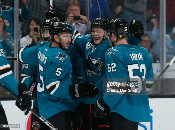 Tomas Hertl, Matt Irwin and Jason Demers of the San Jose Sharks celebrate Hertl's goal against the New York Rangers during an NHL game on October 8,...