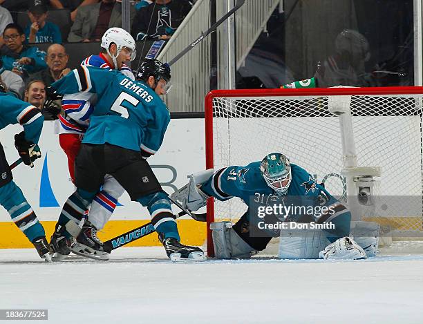 Antti Niemi and Jason Demers of the San Jose Sharks protect the net against the New York Rangers during an NHL game on October 8, 2013 at SAP Center...