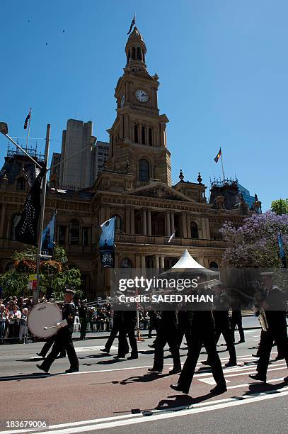 Sailors march past the Sydney Town Hall during a combined navies parade on George Street in the central business district of Sydney on October 9,...