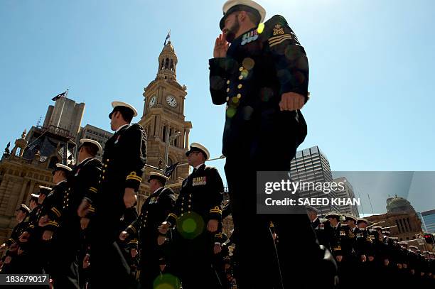 Sailors march past the Sydney Town Hall during a combined navies parade on George Street in the central business district of Sydney on October 9,...