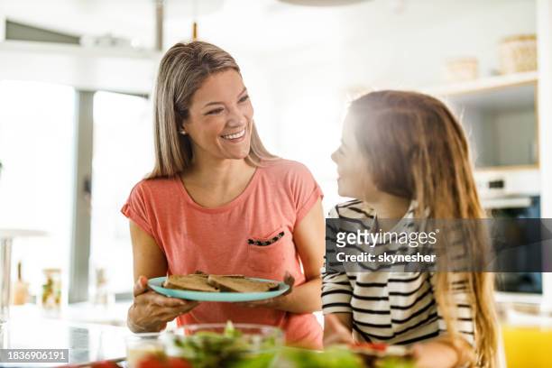 happy single mother and daughter making breakfast in the kitchen. - girl making sandwich stock pictures, royalty-free photos & images