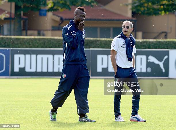 Mario Balotelli of Italy and Doctor Enrico Castellacci at Coverciano on October 9, 2013 in Florence, Italy.