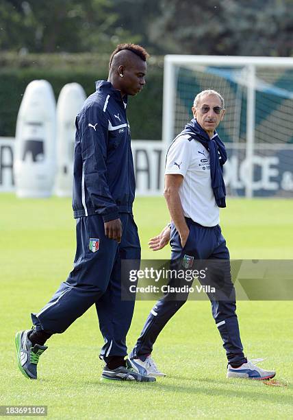 Mario Balotelli of Italy and Doctor Enrico Castellacci at Coverciano on October 9, 2013 in Florence, Italy.