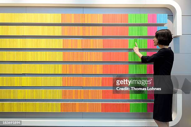 Woman takes a book at the 'Reclame' publishing house stand of the 2013 Frankfurt Book Fair on October 9, 2013 in Frankfurt, Germany. This year's fair...