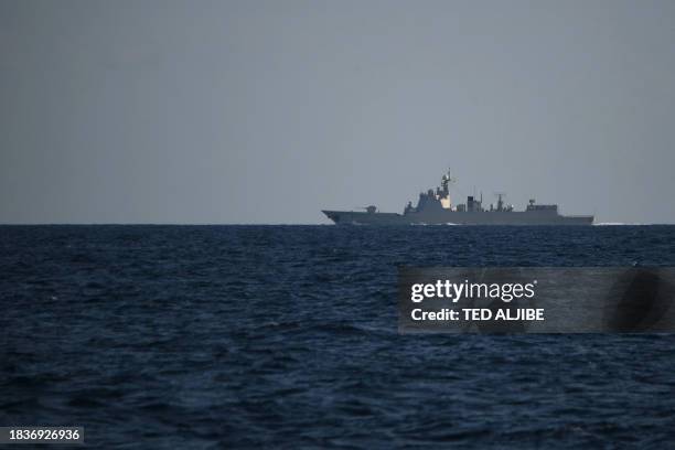 Chinese PLA Navy ship shadows a Philippine vessel that was part of a convoy of civilian boats in the disputed South China Sea on December 10, 2023. A...