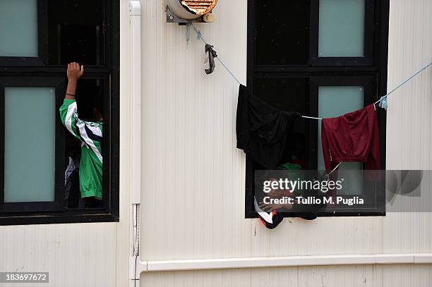 Immigrants are detained after their arrival in the temporary shelter Center on October 8, 2013 in Lampedusa, Italy. The search for bodies continues...