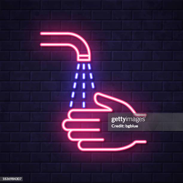 washing hands. glowing neon icon on brick wall background - cleaning wall stock illustrations