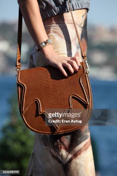 Meltem Ozbek wears her own designed bag during Mercedes-Benz Fashion Week Istanbul s/s 2014 presented by American Express on October 9, 2013 in...