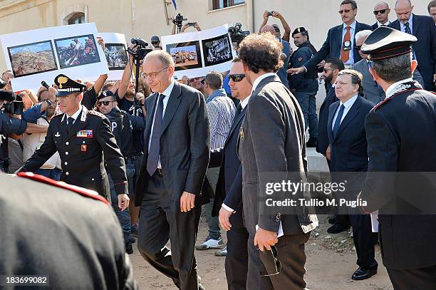 Activists protest as Enrico Letta, Italian Prime Minister, and Manuel Barroso, President of the European Commission leave the Town Hall of Lampedusa...