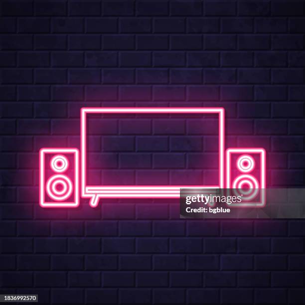 home cinema. glowing neon icon on brick wall background - projection wall studio stock illustrations