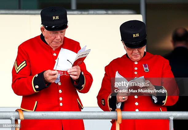 Two Chelsea Pensioners study their race cards as they attend the CAMRA Beer Festival Race Day at Ascot Racecourse on October 5, 2013 in London,...