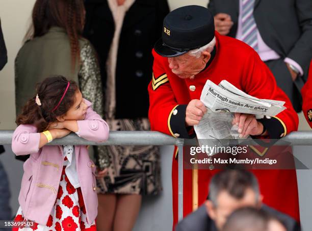 Young girl talks to a Chelsea Pensioner as they attend the CAMRA Beer Festival Race Day at Ascot Racecourse on October 5, 2013 in London, England.