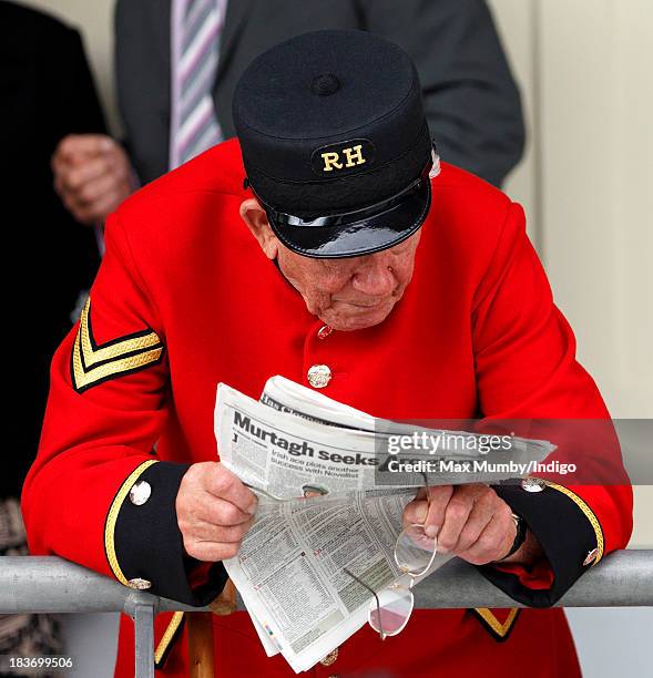 Chelsea Pensioner reads the racing section of a newspaper as he attends the CAMRA Beer Festival Race Day at Ascot Racecourse on October 5, 2013 in...