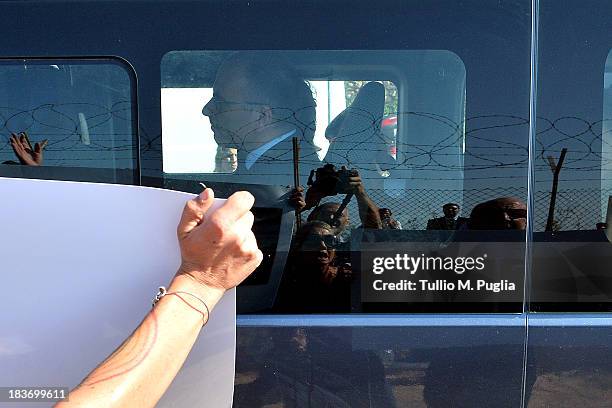 Enrico Letta, Italian Prime Minister is transported on a bus as activists protest outside at Lampedusa Airport during the visit of Manuel Barroso,...