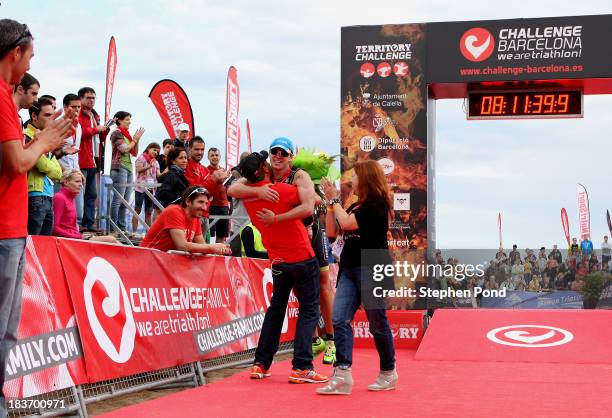Konstantin Bachor of Germany is presented with a bouquet by CEO of Challenge Family Felix Walchshofer after winning the mens event during the...