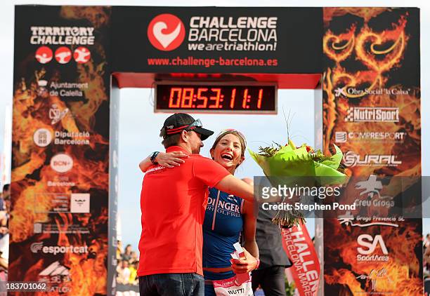 Eva Wutti of Austria celebrates winning the womens event with CEO of Challenge Family Felix Walchshofer during the Challenge Triathlon Barcelona on...