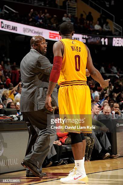 Head coach Mike Brown of the Cleveland Cavaliers talks with C.J. Miles during a break in the action against the Milwaukee Bucks at The Quicken Loans...