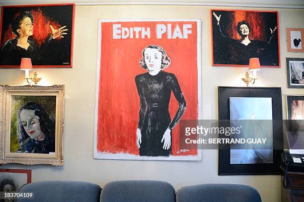 Picture taken on October 9, 2013 shows paintings representing late French singer Edith Piaf displayed in her apartment now turned into a museum in...