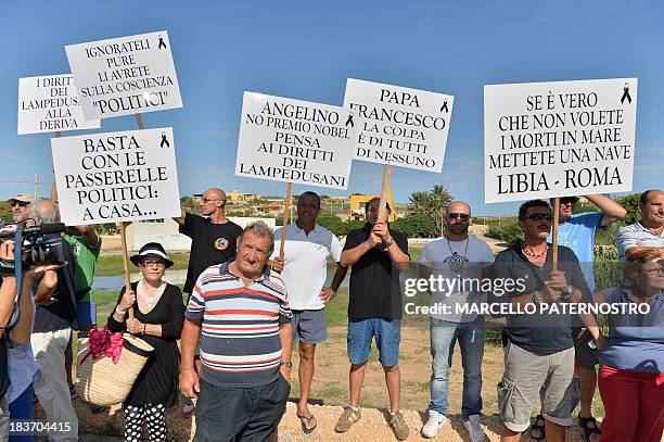 Residents of the southern Italian island of Lampedusa protest on October 9, 2013 against the visit of European Commission chief Jose Manuel Barroso...