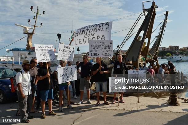 Residents of the southern Italian island of Lampedusa protest on October 9, 2013 against the visit of European Commission chief Jose Manuel Barroso...