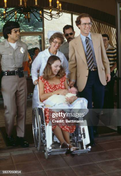 Julie Nixon Eisenhower, husband David Eisenhower and their newborn baby daughter Jennie leaving San Clemente General Hospital in California, August...
