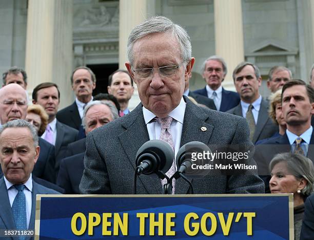 Senate Majority Leader Harry Reid is flanked by Senate Democrats as he speaks to the media during a news conference on the government shutdown at the...
