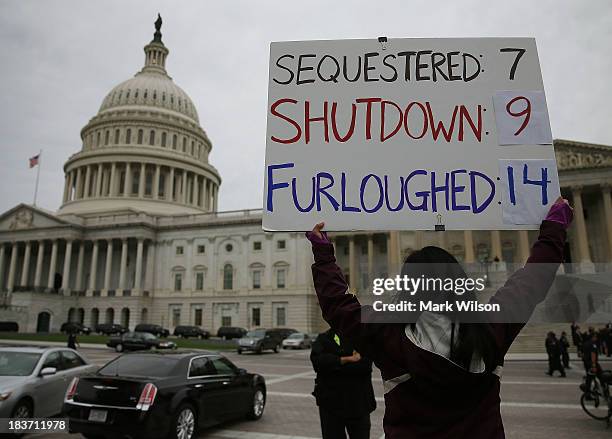 Women holds a sign that reads during a rally in front of the U.S. Capitol, October 9, 2013 in Washington, DC. The U.S. Government shutdown is...