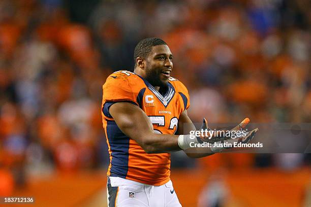 Linebacker Wesley Woodyard of the Denver Broncos cheers on his teammates during a game against the Oakland Raiders at Sports Authority Field Field at...